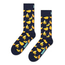 Groene Happy Socks Banana BAN01 fantasiesokken voor dames en heren met gele bananen, gedragen met kleurrijke sneakers. - Jambelles