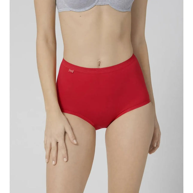 Model draagt een rode dames slip sloggi Basic+ Maxi C3P met hoge taille, gladde voorkant en klein sloggi-label. - Jambelles