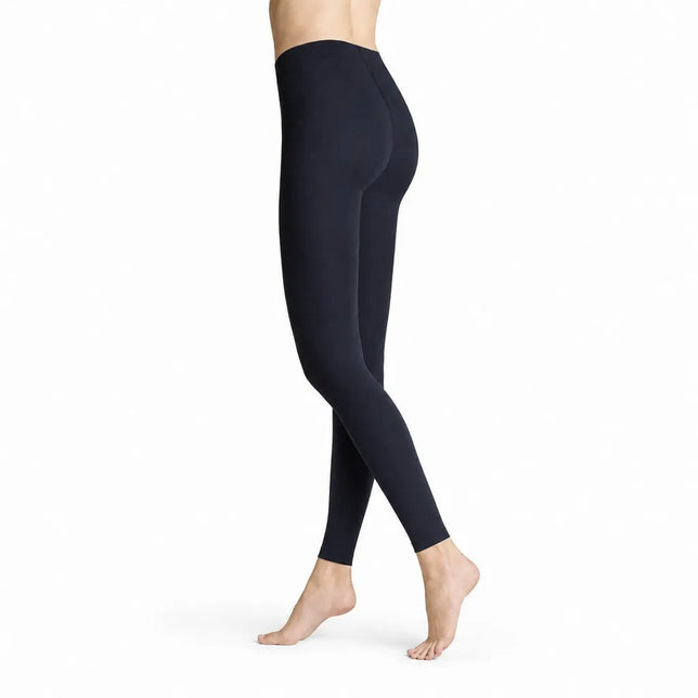 Een model draagt de donkerblauwe Hudson Dames Legging Thermo 120015629, nauwsluitend en enkellang met hoge taille. - Jambelles
