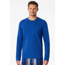 Blauw shirt met lange mouwen en ronde hals van een niet zichtbaar merk, effen uitgevoerd en gedragen door een man. - Jambelles