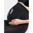 Detail van zwarte Wolford Maternity Treasure dameslegging met twee grijze babyvoetafdrukken. - Jambelles